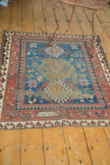 Antique Caucasian rug: central holed areas, exposed foundation, and geometric motifs.