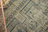 Antique Caucasian geometric patterns in navy, sand, ivory, revealing patinated texture.