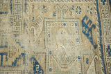 Hard tatter visible on antique Caucasian rug pile, featuring geometric guls in navy and oxidized green.