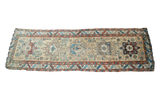 Antique Northwest Persian runner, yellow beige field with geometric patterns, teal and red accents.
