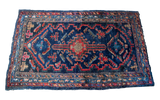 Dark indigo blue vintage Lilihan rug with central geometric medallion and bold red motifs, 2'8