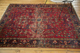 Persian Lilihan rug's lower border in navy, showing floral vinery and exposed edge foundation.