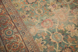 Detailed madder root red border and abrashed emerald green field of antique Mahal carpet.