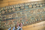 Antique Caucasian runner with repeating boteh motifs in mauve, gold, blue, and even wear.