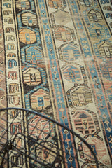 Triple column boteh motif on an antique Caucasian runner, showing aged hues of gold, mauve, and blue.