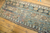 Geometric triple column boteh motif on an antique Caucasian runner with visible foundation wear.