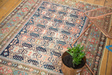 Antique Shirvan rug's repeating crab style medallions with indigo and madder red tones.