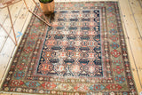Antique Caucasian Shirvan rug's geometric crab medallion motif in indigo and madder root, with textural patina.