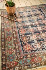 Shirvan rug's distinct geometric borders and crab style medallion motif.