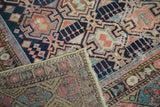 Antique Shirvan rug's indigo, red geometric pile contrasted with its hand-knotted back.