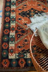 Vintage Afghan Tent Cover runner detail: brick red, navy, green geometric and curvilinear border patterns.