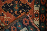Folded vintage Afghan Tent Cover rug corner, revealing brick red geometric pile and woven back.