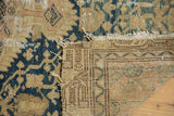 Close-up of a vintage Tajabad rug corner, revealing distressed dark blue pile, tatter, and foundation weave.