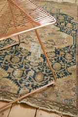 Storied corner of the vintage Tajabad rug with aged fringe and teal patterned border.
