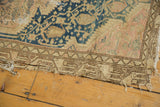 Vintage Tajabad rug's worn edge with intricate border, showcasing tatter and loss.