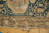 Close-up of vintage Tajabad rug lower border featuring chocolate brown geometric patterns and frayed edge.