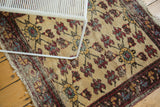 Vintage Turkish rug detail: wine red floral cross-sections, sky blue, short worn pile.
