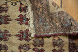 Short pile ivory field with red floral motifs and vintage Turkish hand-knotted foundation.