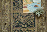 Antique Perpedil Caucasian rug: dusty teal field with rams horn and animal motifs, geometric border.
