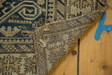 Tattered side edge and hand-knotted reverse of an antique Perpedil Caucasian rug.