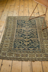 Tattered end of antique Perpedil rug, revealing pawn and ribboned minor borders in beige and mauve.