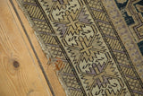 Antique Perpedil Caucasian rug's tattered edge, detailed geometric rams horn pattern in beige and mauve.