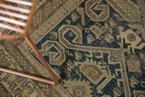 Geometric rams horn motifs on a dusty teal field of an antique Perpedil Caucasian rug.