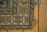 Antique Perpedil Caucasian rug corner with geometric crab border in beige, brown, and teal.
