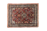 Vintage Sarouk rug mat, cherry red field with a quatrefoil medallion and detailed floral design.