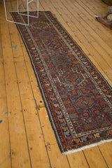 Vintage Karaja runner corner with white fringe, rainbow leaf border, and low, geometric field.