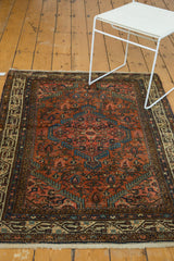 Vintage Tajabad corner: finely woven blush field, blue motifs, ivory border design, and fringe.