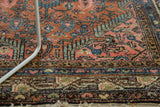 Finely woven vintage Tajabad rug detail, highlighting blush, brick red, and sky blue curvilinear motifs.