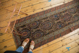 Antique Northwest Persian runner, featuring repeating boteh motifs in charcoal, teal, madder red, and fringe.