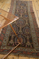 Antique Northwest Persian runner showing repeating boteh with haloed germinating plants and fringe.