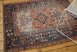 Vintage Karaja rug: brick red field, navy border with germinating plants, visible wear.