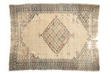 Antique Persian Doroksh rug, ivory field, navy medallion, and storied patina, 4'6