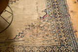 Visible foundation and historical wear on an antique Doroksh rug, with patterned border.