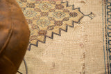 Antique Persian Doroksh rug pile displaying extensive tatter and exposed beige foundation.