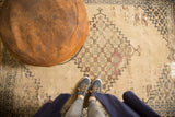 Antique Doroksh rug, ivory field featuring blue, mauve floral motifs, and extensive visible reweaving.