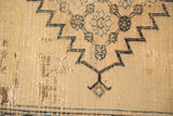Extensive tatter and various reweaves on antique Doroksh rug's beige foundation.