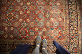 Hand-knotted vintage Mahal rug close-up, highlighting allover repeating floral motifs, cherry red field, and lower pile areas.