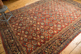 Intricate allover repeating pomegranate floral pattern of the vintage Mahal carpet in cherry red and navy.