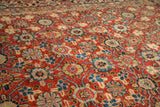 Repeating floral pomegranate motifs and lattice on a cherry red vintage Persian Mahal rug.