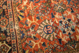 Vintage Mahalati carpet border and field, terra cotta, navy, and sage palmette motifs.