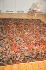 Vintage Mahalati carpet corner with navy blue border and rust allover palmette field.