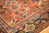 Oversized palmettes and lotus flowers on terra cotta field, vintage Mahalati rug's navy border.
