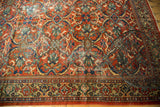 Hand knotted Mahal carpet detail, showing brick red field, decorative border, and aged textural patina.
