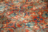 Vintage Mahal carpet pile with curvilinear lotus and leaf motifs, brick red and blue texture.