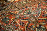 Ornate floral motifs in brick red, teal, and ivory of a vintage Persian Mahal rug.