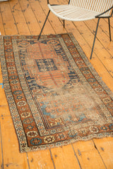 Antique Kurdish runner corner, with heavy foundation wear, tattered ends, and terra cotta geometric borders.